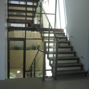 Floating Steel Stairway with Concrete Steps and Glass Railing